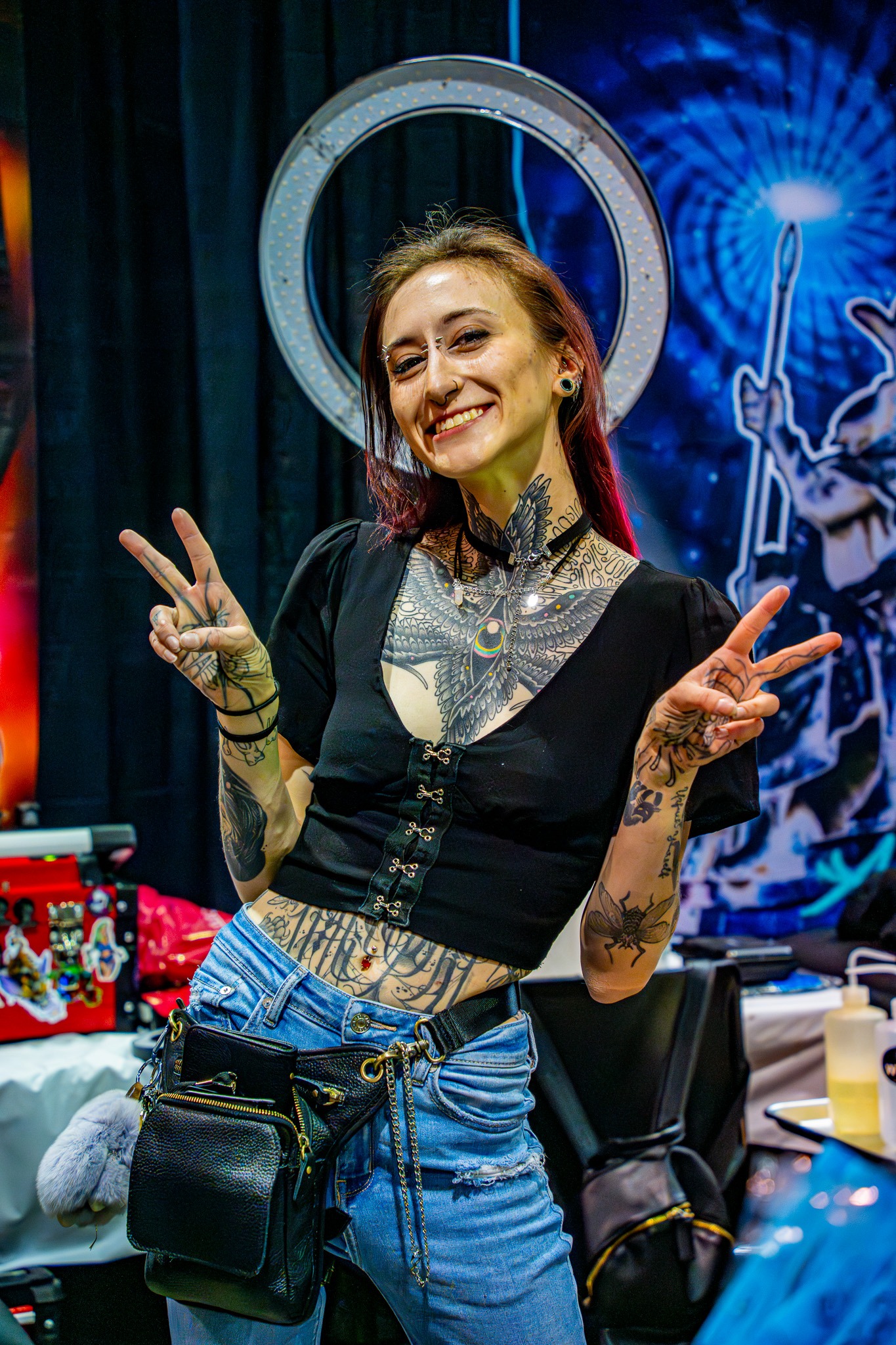 Tattoo artist smiling and making peace signs