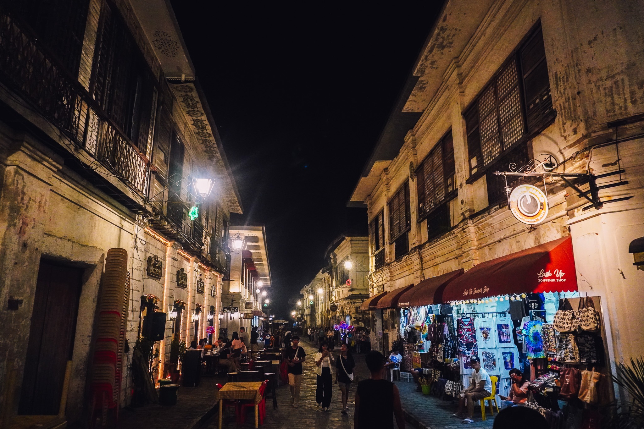 Historic street in Vigan illuminated at night
